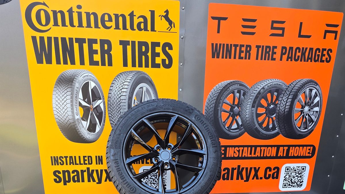 New Continental VikingContact winter tires on gloss black wheels stacked in front of the Sparky X trailer — Continental Winter Tires and Tesla Winter Tire Packages signage, sparkyx.ca