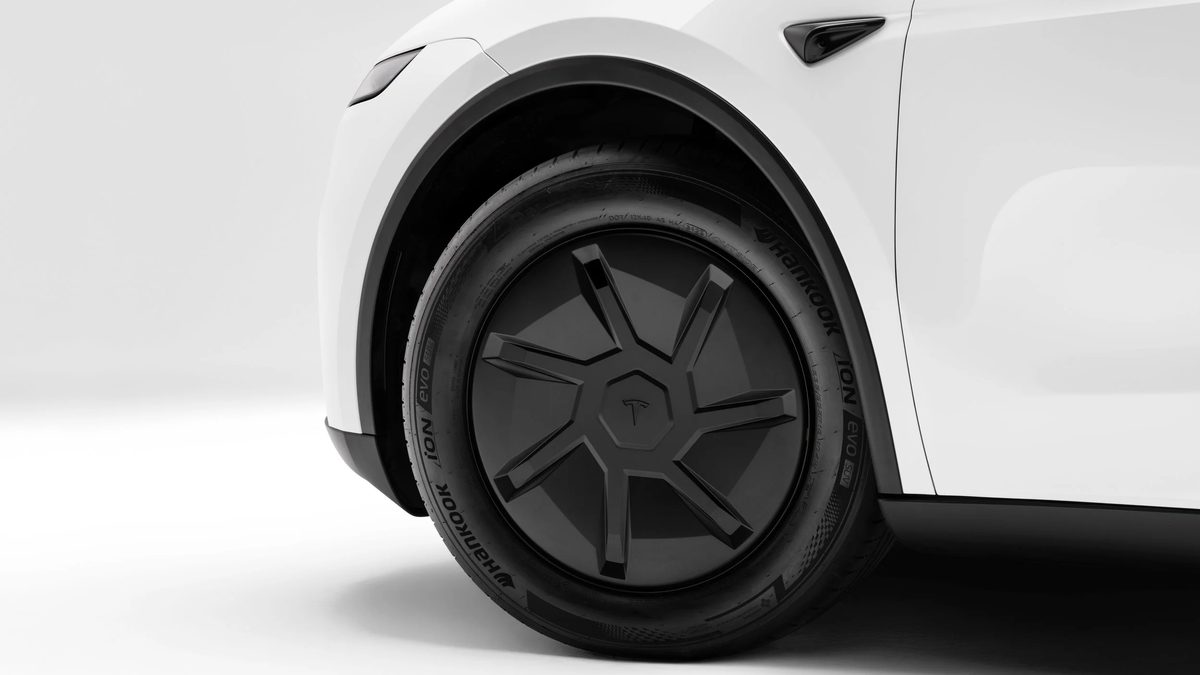 Tesla Model Y wheel close-up — the 2026 Standard trim deleted its TPMS sensors for indirect TPMS