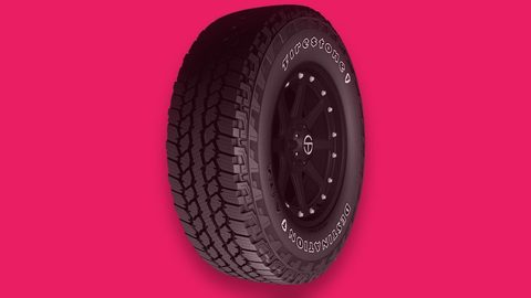 Firestone Destination A/T2 all-terrain tire on a hot pink background