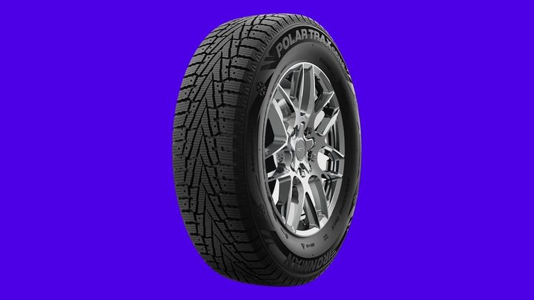 Ironman Polar Trax Gen2 winter tire on an electric indigo background